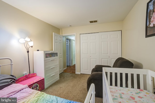 carpeted bedroom with a closet