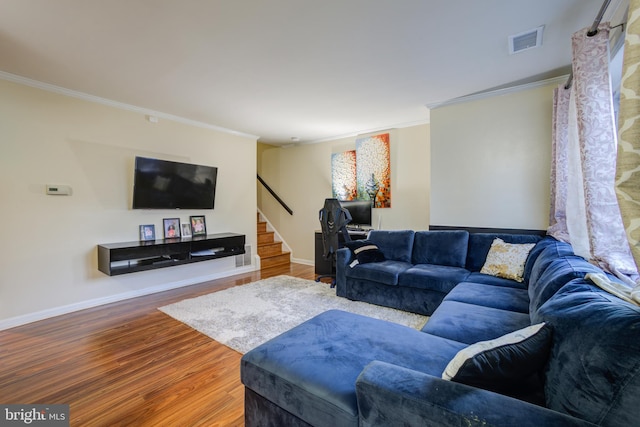 living room featuring hardwood / wood-style floors and crown molding