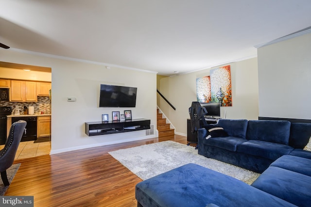 living room with light hardwood / wood-style floors and ornamental molding