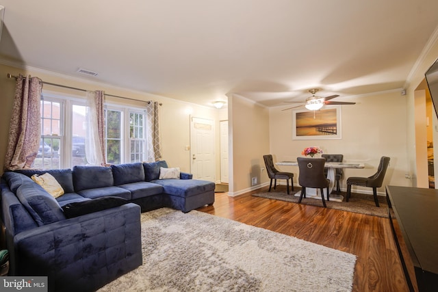 living room featuring hardwood / wood-style floors, crown molding, and ceiling fan