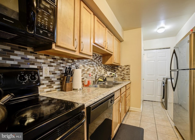 kitchen with light brown cabinetry, black appliances, light tile patterned floors, and backsplash