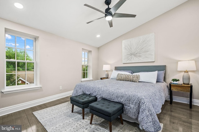 bedroom with dark wood-type flooring, multiple windows, ceiling fan, and vaulted ceiling