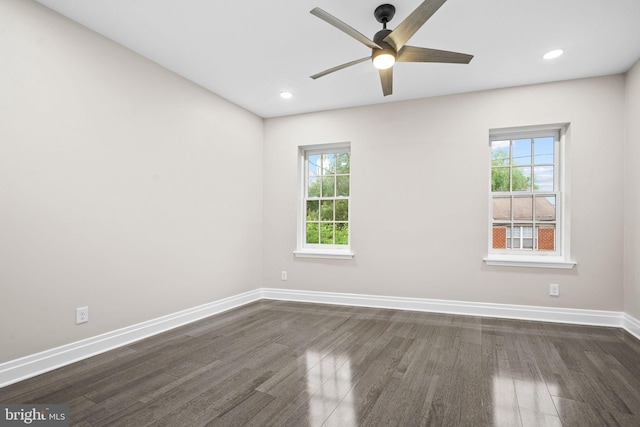 unfurnished room with dark wood-type flooring, ceiling fan, and a healthy amount of sunlight