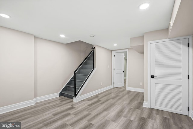 basement with light hardwood / wood-style floors