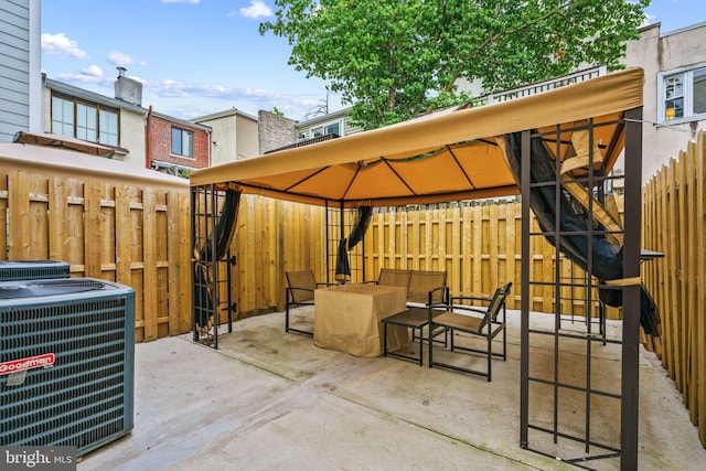 view of patio featuring central AC and a gazebo