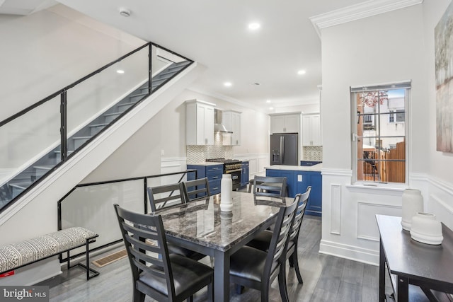 dining room featuring dark hardwood / wood-style flooring and ornamental molding