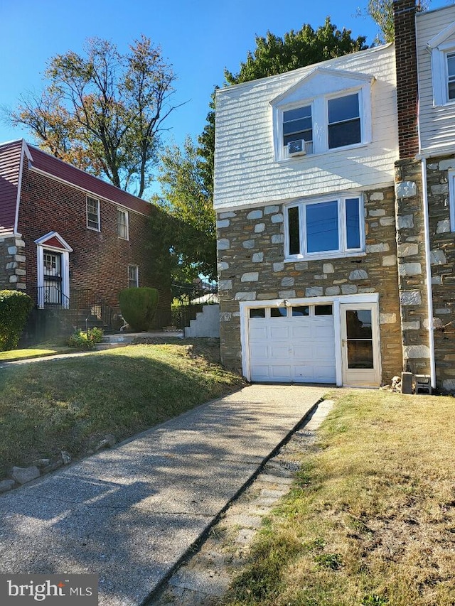 view of side of property featuring a yard and a garage