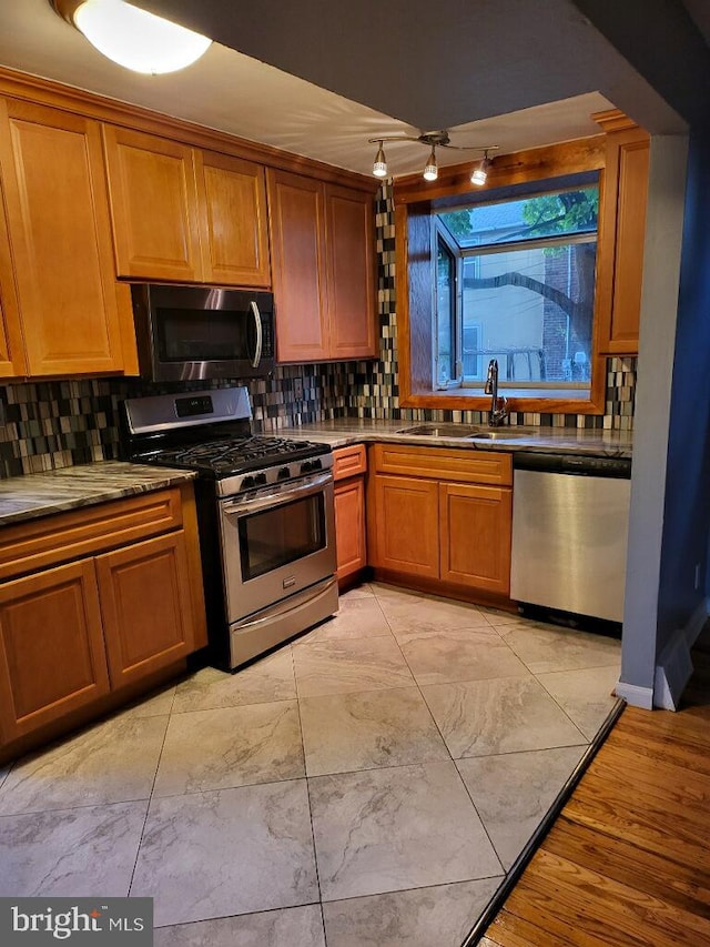 kitchen with backsplash, sink, and stainless steel appliances