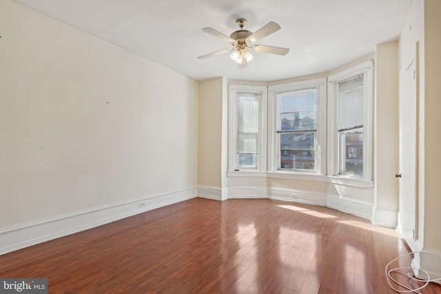 unfurnished room with hardwood / wood-style floors and ceiling fan