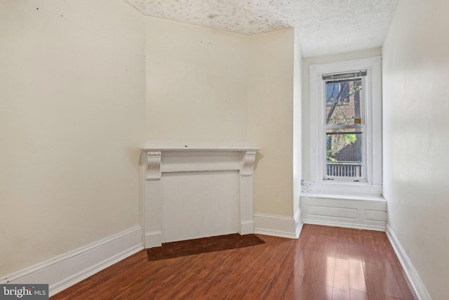 empty room featuring hardwood / wood-style floors and a textured ceiling