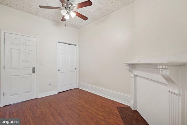 unfurnished bedroom featuring dark wood-type flooring and ceiling fan