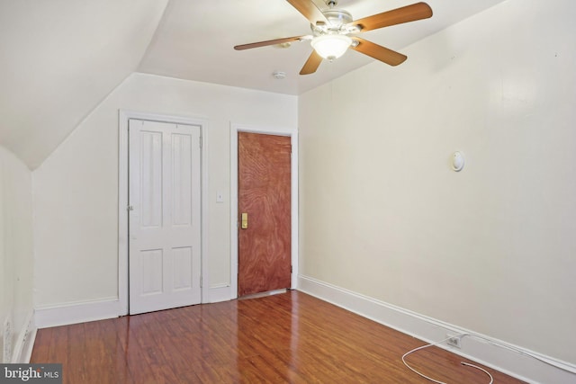 unfurnished bedroom with a closet, ceiling fan, vaulted ceiling, and hardwood / wood-style floors