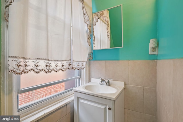 bathroom with vanity and tile walls