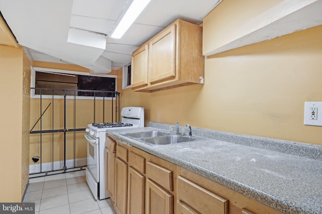 clothes washing area featuring sink and light tile patterned floors