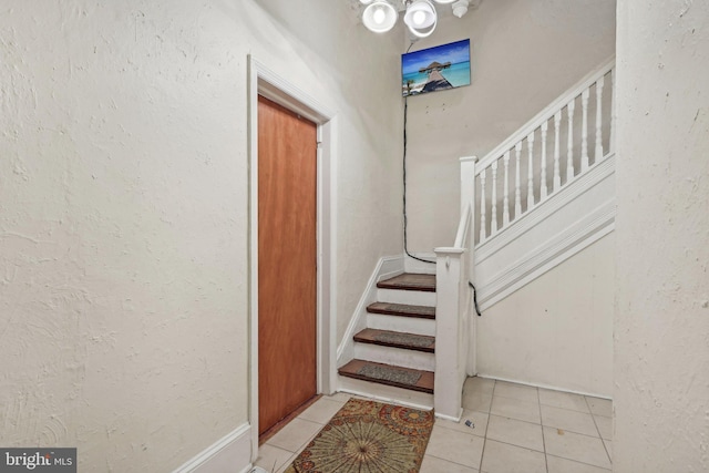 stairs featuring tile patterned flooring