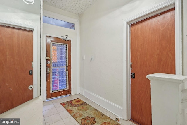 foyer with lofted ceiling and light tile patterned floors