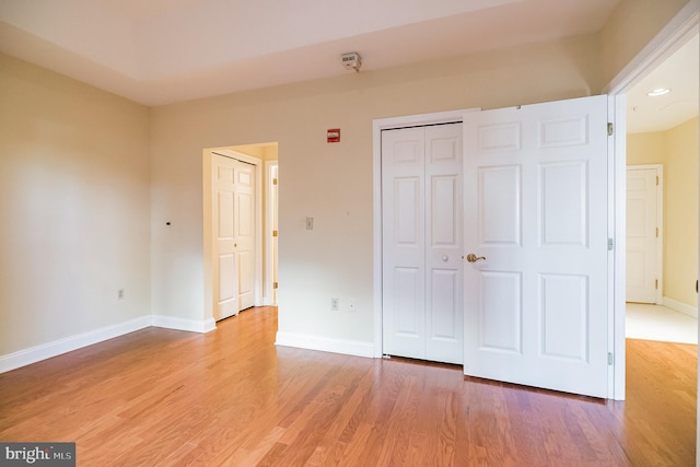 unfurnished bedroom with hardwood / wood-style floors