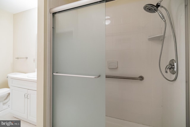 bathroom with vanity, an enclosed shower, and toilet