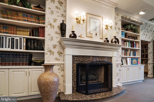 living area with dark carpet, ornamental molding, and a high end fireplace