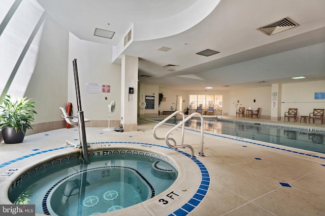 view of swimming pool featuring an indoor hot tub