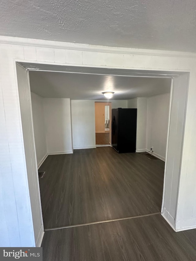 interior space with dark wood-type flooring and a textured ceiling