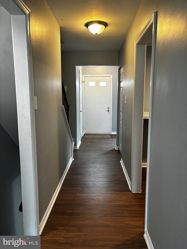 corridor with dark wood-type flooring