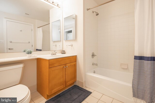 full bathroom featuring vanity, shower / tub combo with curtain, toilet, and tile patterned floors