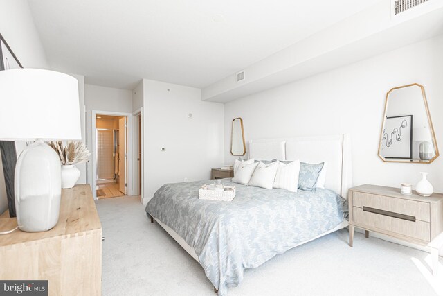 carpeted bedroom featuring ensuite bathroom