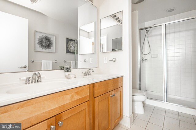 bathroom with vanity, toilet, tile patterned floors, and walk in shower