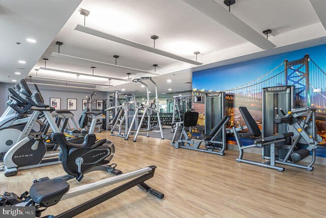 workout area featuring a textured ceiling and hardwood / wood-style flooring