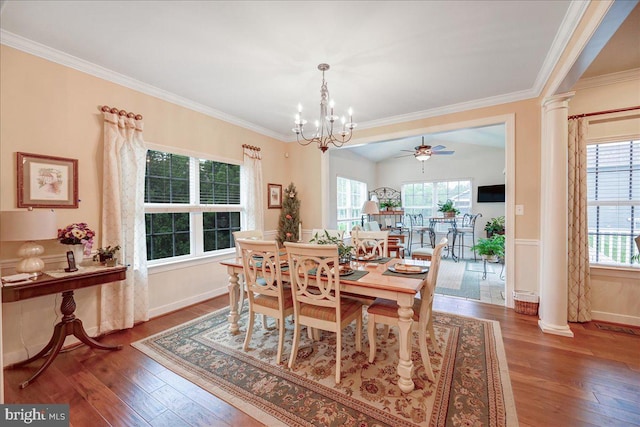 dining room featuring hardwood / wood-style flooring, ceiling fan with notable chandelier, and decorative columns