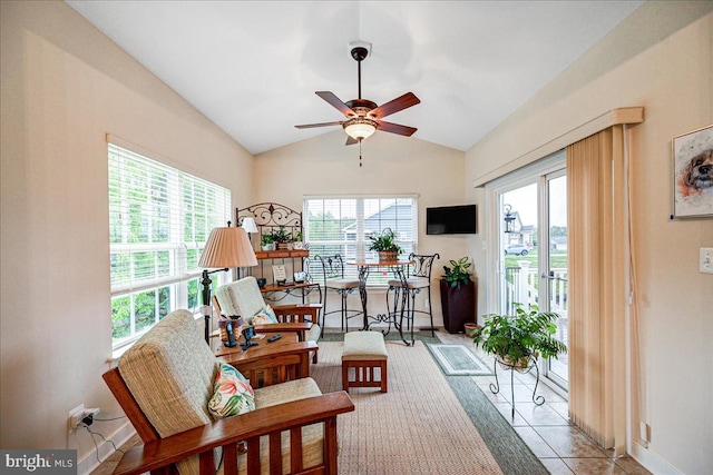 living area featuring vaulted ceiling, ceiling fan, and light tile patterned flooring