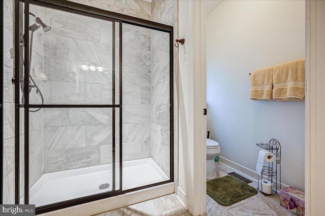 bathroom with toilet and an enclosed shower