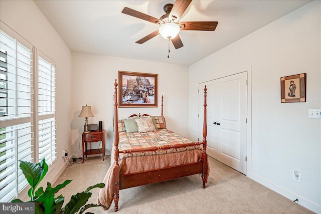 carpeted bedroom featuring a closet and ceiling fan