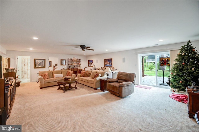 carpeted living room featuring ceiling fan