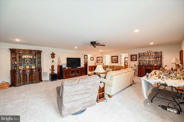 carpeted living room featuring ceiling fan