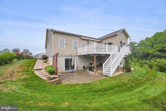 back of house featuring a patio, a deck, and a lawn