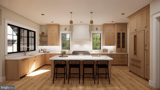 kitchen featuring a kitchen island, light hardwood / wood-style flooring, and a healthy amount of sunlight