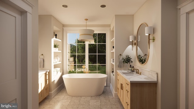 bathroom featuring vanity, tile patterned flooring, and a tub