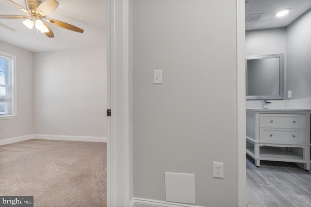 hallway with light colored carpet