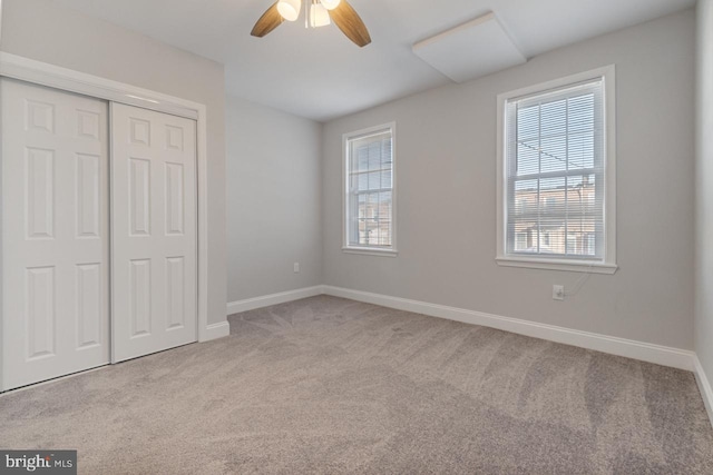 unfurnished bedroom featuring a closet, ceiling fan, and light carpet