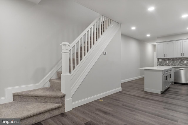 stairs featuring hardwood / wood-style floors