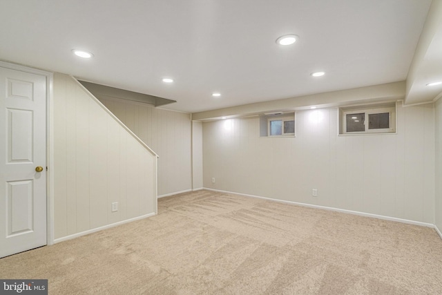 basement featuring light colored carpet