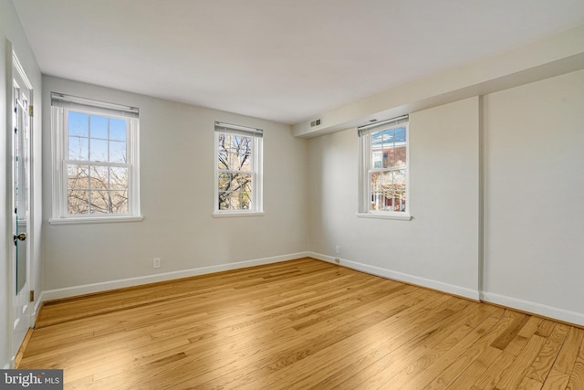 spare room with light hardwood / wood-style floors