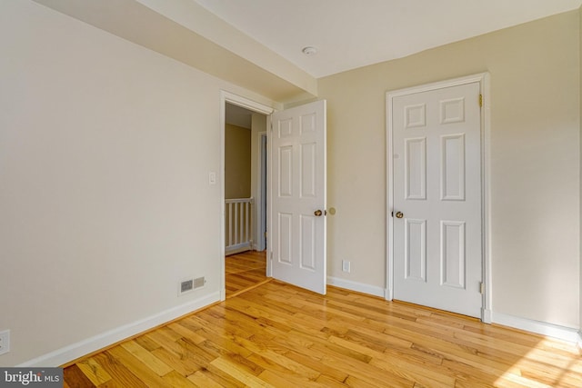 empty room with light hardwood / wood-style flooring