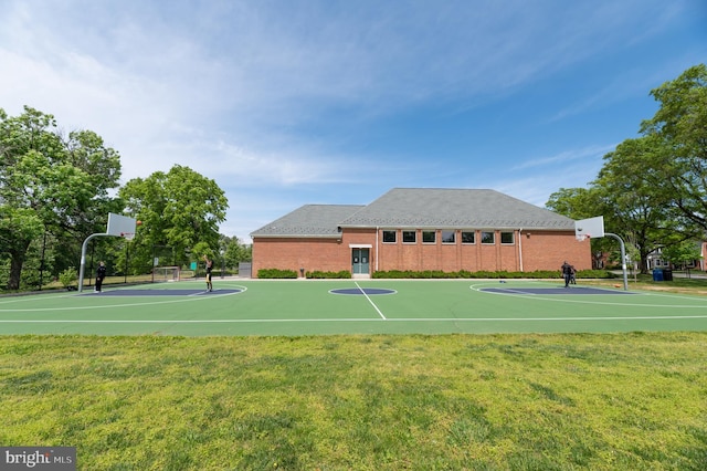 view of sport court with a lawn