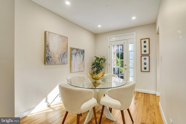 dining space with light hardwood / wood-style flooring