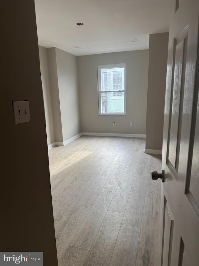 spare room featuring light hardwood / wood-style floors