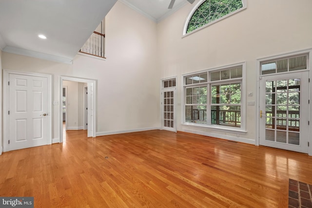 unfurnished living room with light hardwood / wood-style flooring and a wealth of natural light