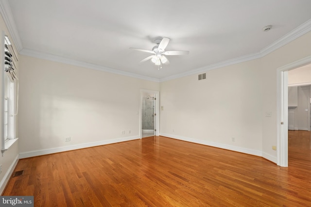 spare room with crown molding, hardwood / wood-style flooring, and ceiling fan